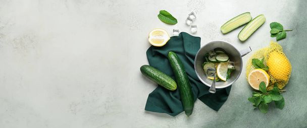 Pot of lemonade with cucumber and mint on grunge background with space for text - Photo, Image