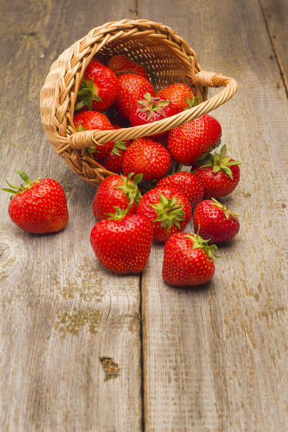 Strawberries in basket on a wooden table - Photo, Image