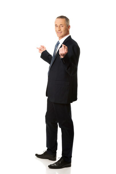 Businessman with hands on both sides - Foto, imagen