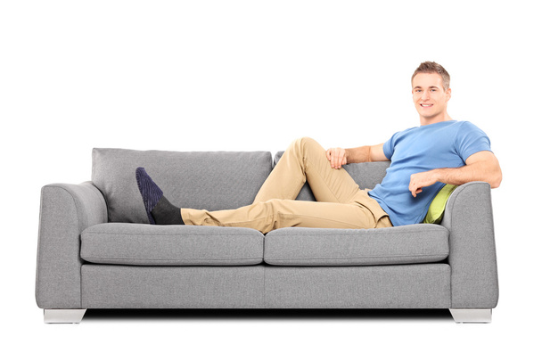 Relaxed young man on sofa - Foto, Imagen