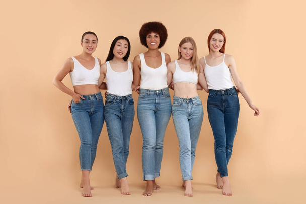 Group of beautiful young women on beige background - Фото, зображення