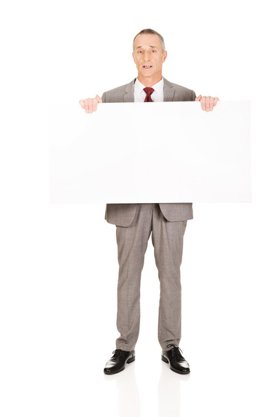 Businessman holding empty banner - Фото, изображение