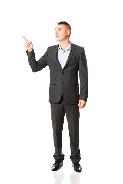 Businessman pointing away - Фото, изображение