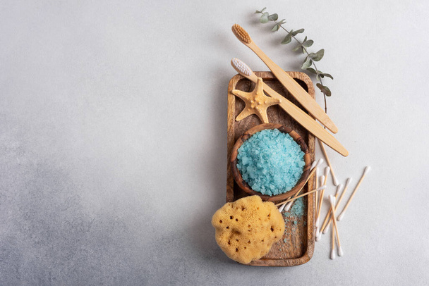 Bath Spa Setting with sea salt, natural wild sponge and bamboo toothbrushes. Concept for sustainable leaving. - Fotó, kép