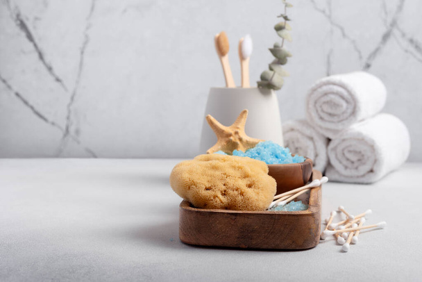 Bath Spa Setting with blue sea salt, natural wild sponge and bamboo toothbrushes. Concept for sustainable leaving. - 写真・画像