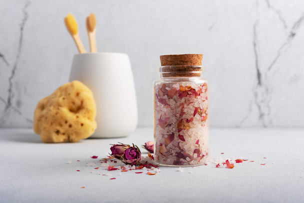 Still life with homemade roses bath salt, bamboo toothbrushes and natural sea sponge. Skincare spa beauty bath cosmetic products for relax and eco friendly life style - 写真・画像