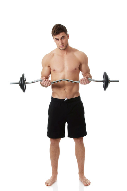 Muscular sports man weightlifting. - Fotó, kép