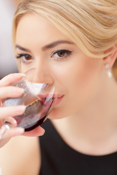 Young woman  drinking wine - Fotó, kép