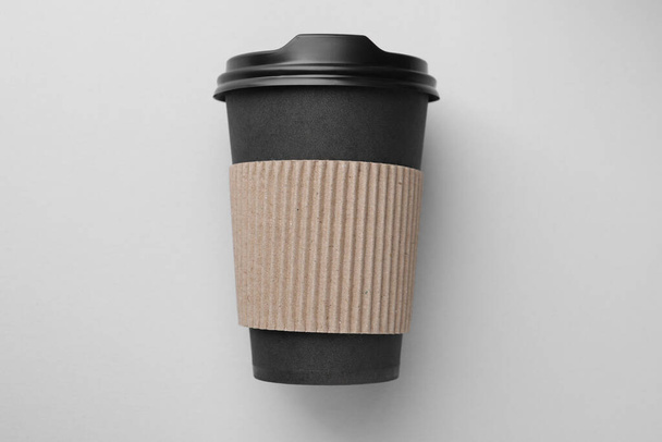 One paper cup on light grey background, top view. Coffee to go - Foto, afbeelding