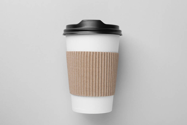 One paper cup on light grey background, top view. Coffee to go - Фото, изображение