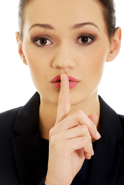 Businesswoman with her finger on lips. - Photo, image