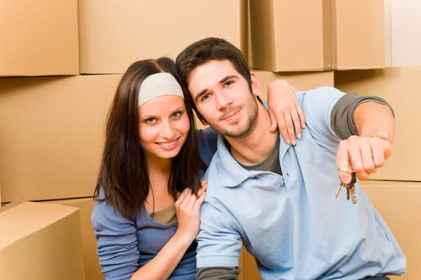 Moving new home young couple hold keys - Fotoğraf, Görsel