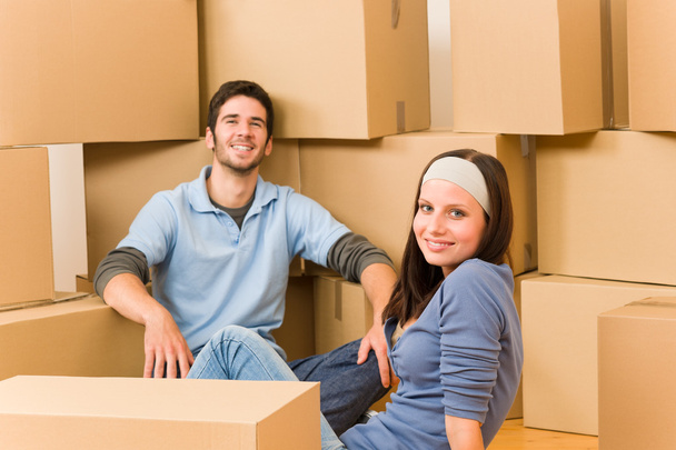 Moving new home young couple sitting floor - Photo, image