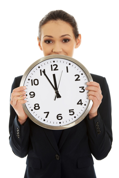 Businesswoman holding a big clock. - Фото, зображення