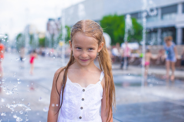 Little girl have fun in outdoor fountain at hot day - Zdjęcie, obraz