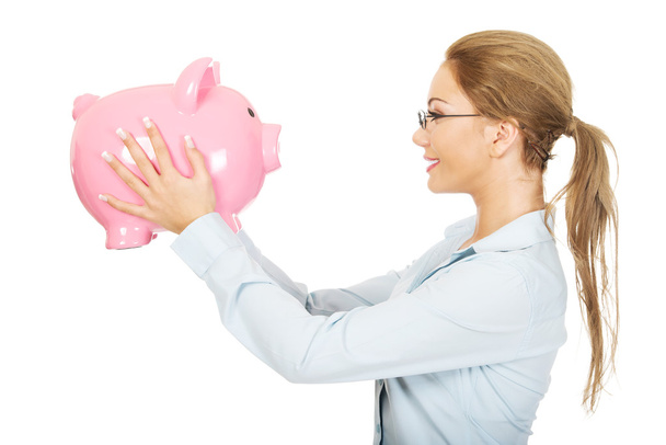 Woman holding piggy bank. - Foto, Imagen