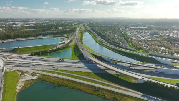 Aerial view of american freeway intersection with slow driving cars during rush hour in Miami, Florida. View from above of USA transportation infrastructure. - Footage, Video