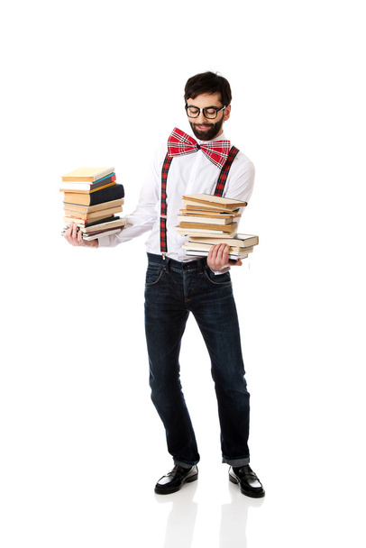 Man with stack of books. - 写真・画像
