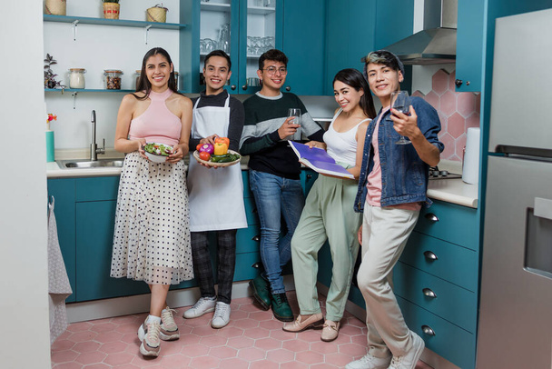 latin LGBT friends cooking and preparing mexican food in kitchen at home in Mexico, Hispanic homosexual people from lgbtq community in Latin America - Photo, Image