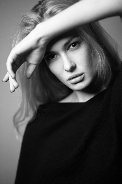 Beautiful blonde girl in a shirt with a light make-up and loose hair. Model tests. - Foto, afbeelding