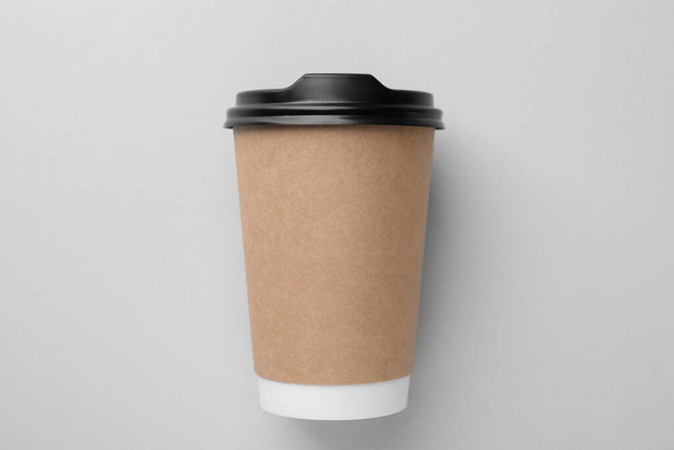 One paper cup on light grey background, top view. Coffee to go - Zdjęcie, obraz