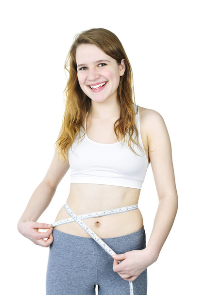 Happy young girl measuring her waist - Foto, immagini