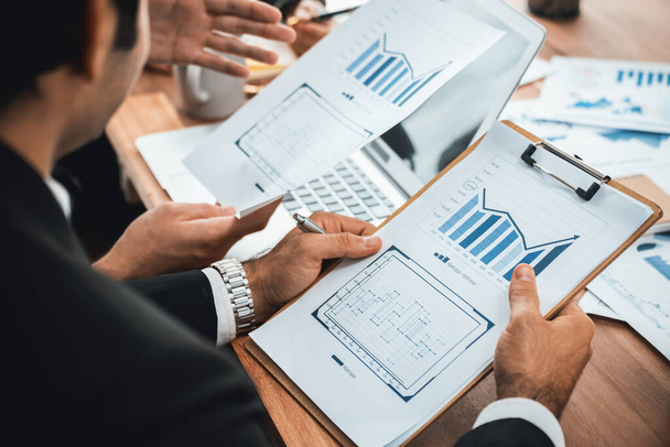 Diverse group of business analyst team analyzing financial data report paper on office table. Chart and graph dashboard by business intelligence analysis for strategic marketing planning Meticulous - Photo, Image