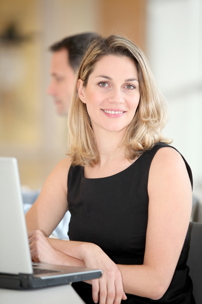 Businesswoman sitting in the office in front of laptop - Photo, image