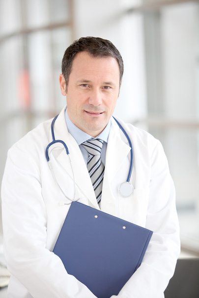 Portrait of doctor standing in hospital corridor - Zdjęcie, obraz