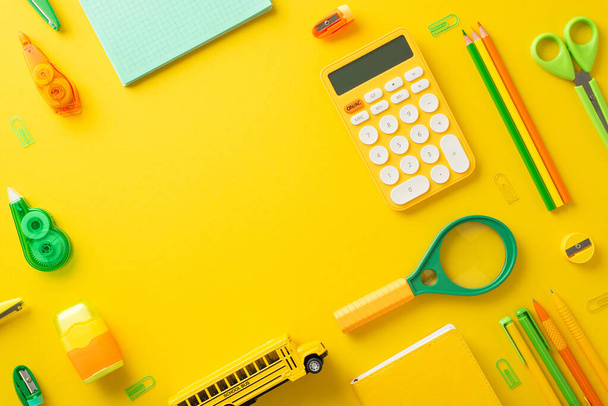 Create the perfect study zone with this student's workplace concept. Above view photo of calculator and colorful academic supplies on yellow isolated background, with copyspace for text or advertising - Photo, Image
