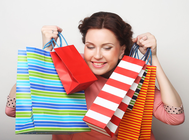 beautiful young woman with colored shopping bags - Foto, Imagen