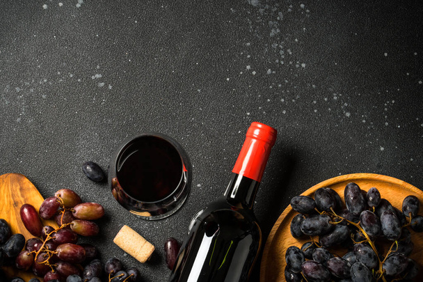 Kırmızı şarap siyah arka planda. Bir bardak şarap, şişe ve krep. Kopyalama alanı olan üst görünüm. - Fotoğraf, Görsel