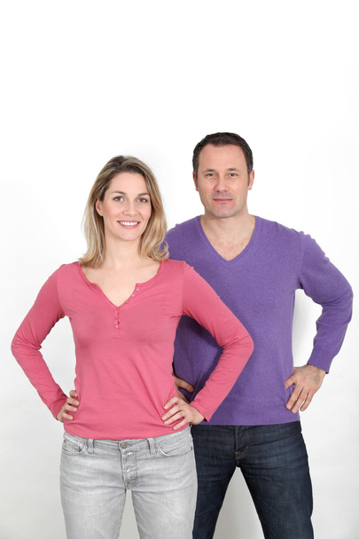 Couple standing on white background with hands on hips - Photo, image