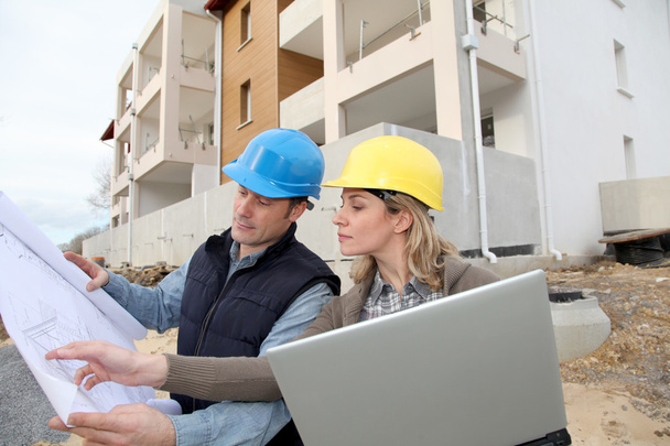 Architect and engineer looking at plan on construction site - Foto, Imagem