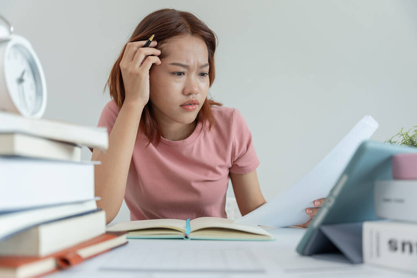 Asian student woman have anxiety because of exams, female prepare for test and learning lessons in the library. stress, despair, haste, misunderstanding reading, discouraged, expectation, knowledge - Zdjęcie, obraz