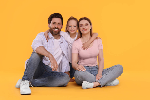 Portrait of happy family on orange background - Фото, зображення