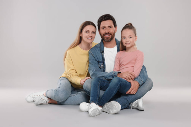Portrait of happy family on light grey background - Фото, изображение