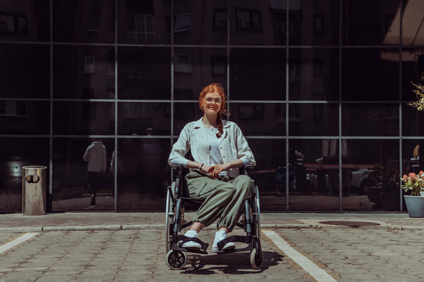 In front of a modern corporate building, a young woman sitting in a wheelchair confidently, symbolizing empowerment, inclusivity, and the strength to overcome challenges in the business world.  - Fotoğraf, Görsel