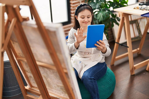 Young woman with down syndrome artist having video call drawing at art studio - Photo, Image
