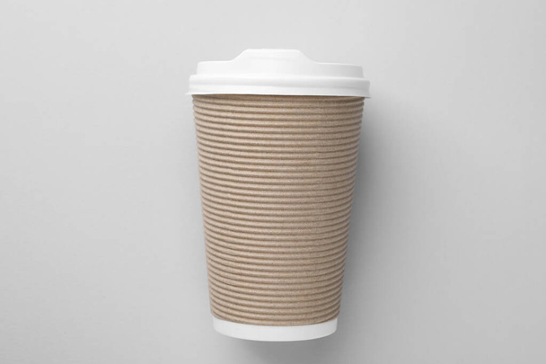 One paper cup on light grey background, top view. Coffee to go - Foto, Bild