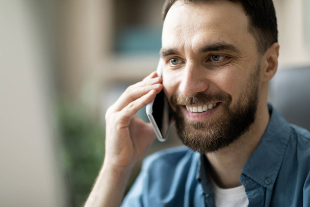 Mobile Call. Happy Young Man Talking On Cellphone And Smiling, Closeup Shot Of Cheerful Handsome Male Having Pleasant Phone Conversation, Enjoying Modern Communication, Selective Focus - Photo, Image