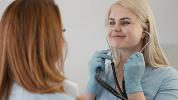 Medical examination: The doctor examines the patient with a stethoscope, providing competent care and professional assistance in the clinic. Hospital visit: The patient performs an appointed medical - Footage, Video