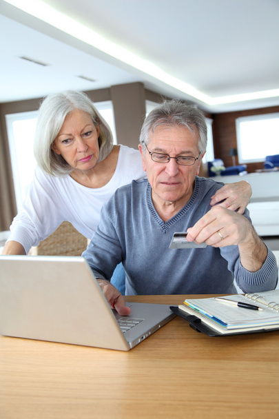 Senior couple making secured payment on internet - Foto, imagen