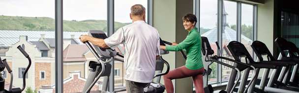 active seniors, cheerful woman looking at elderly man, exercising together, senior couple, banner - Photo, Image