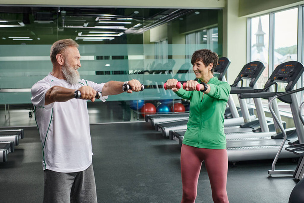 pareja de ancianos, feliz hombre y mujer haciendo ejercicio con pesas, personas mayores activas, marido y mujer - Foto, imagen