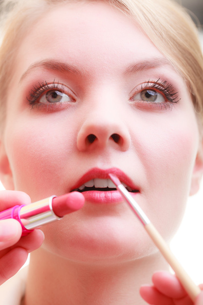Woman applying red lipstick - Fotó, kép