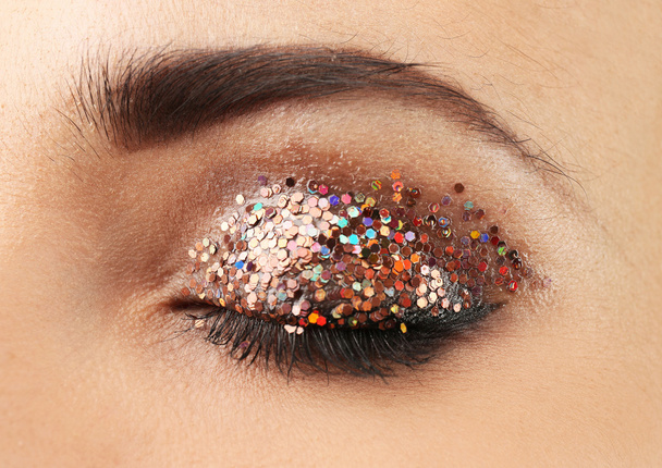 Female eye with fancy glitter makeup, macro view - Valokuva, kuva