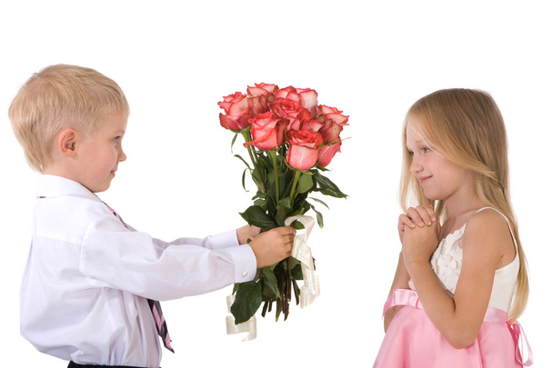 Little gentleman giving bouquet of roses to a cute blonde - Photo, Image