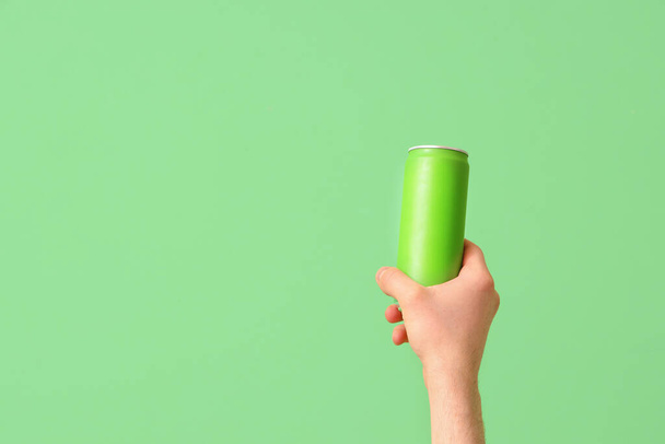 Man with can of beer on green background - Photo, Image