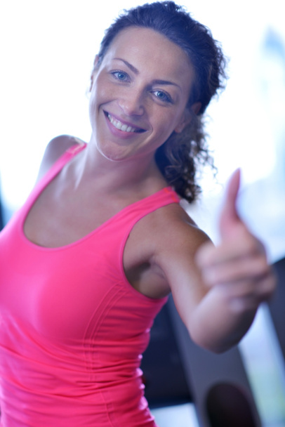 Woman exercising on treadmill in gym - 写真・画像